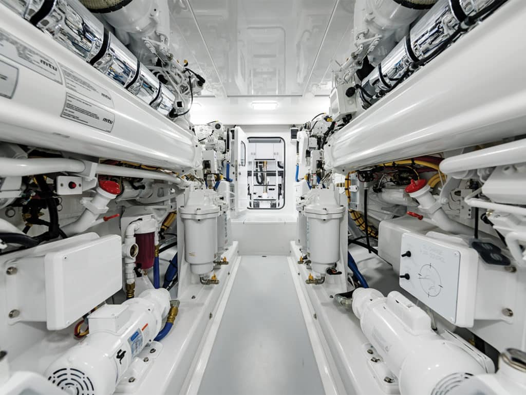 The clean, white engine room of the Bayliss Boatworks 62 sport-fishing boat