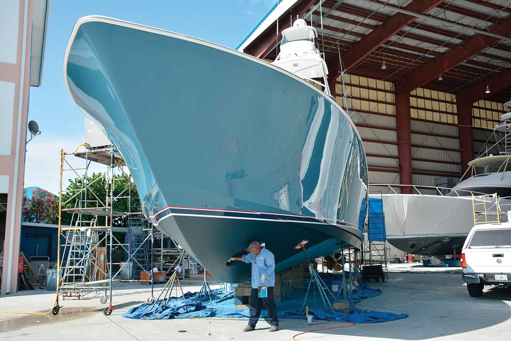 boat with a blue hull in dry docks