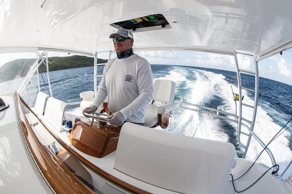 A boat captain steering a ship.