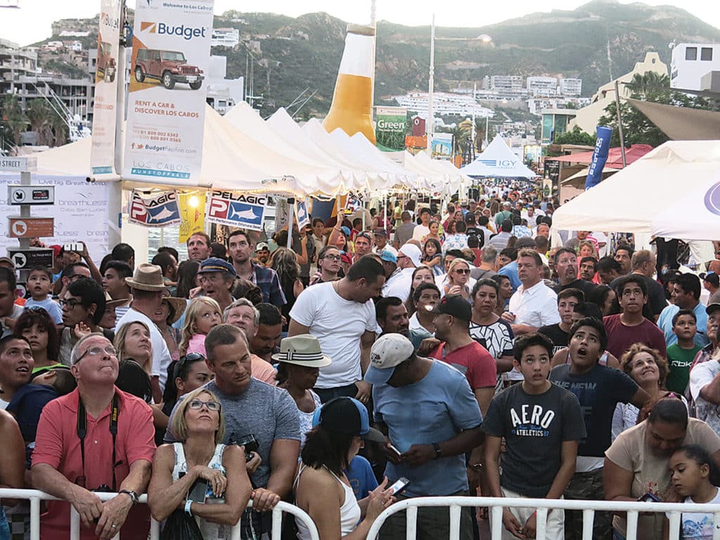 A large crowd gathers in the streets of Cabo.