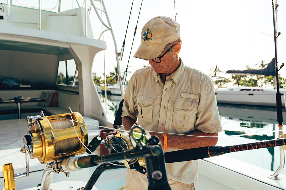 boat captain prepares tackle for fishing