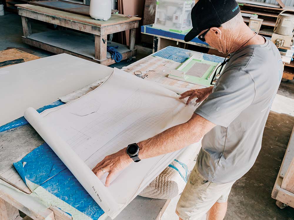 john bayliss looking at a boat build