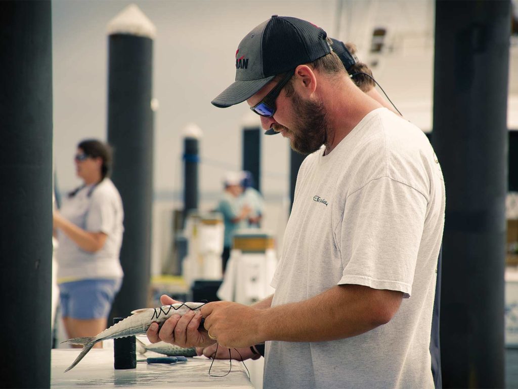 A man rigs and prepares bait.