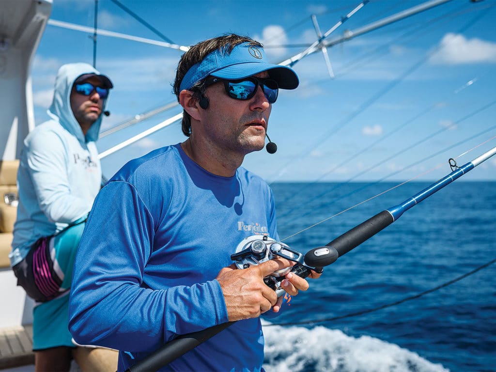 two men fishing off a boat deck