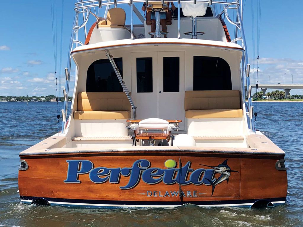 The boat transom with the words "Purfeita" on the back.