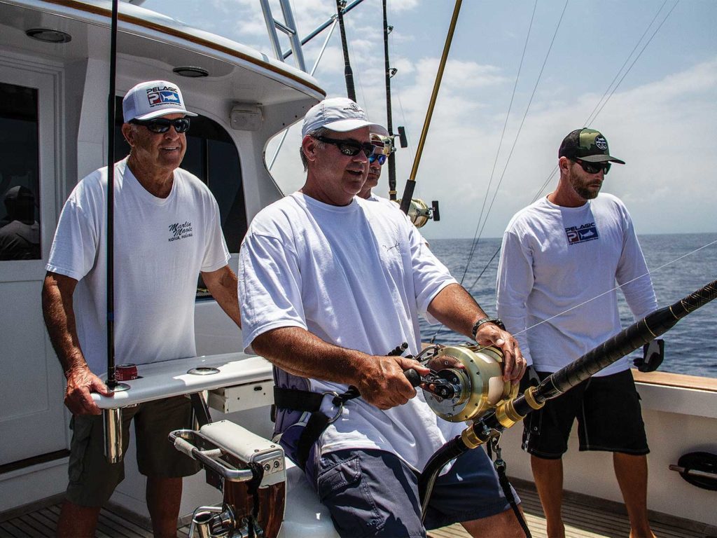 three men in white shirts fishing on a boat deck