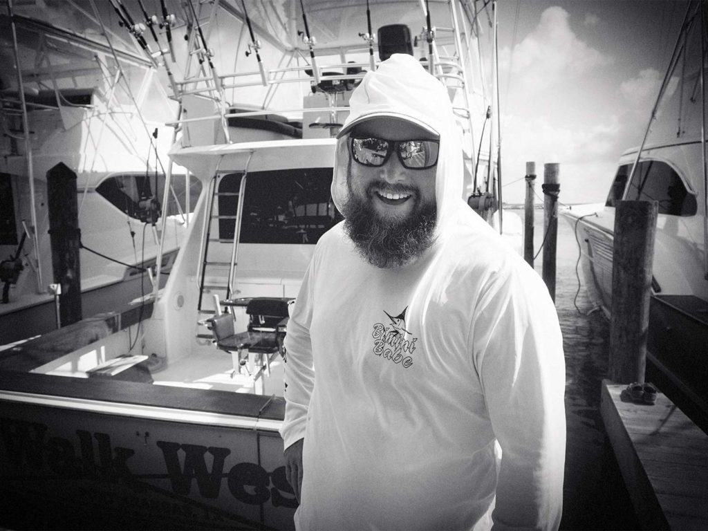 A black and white image of a boat captain.