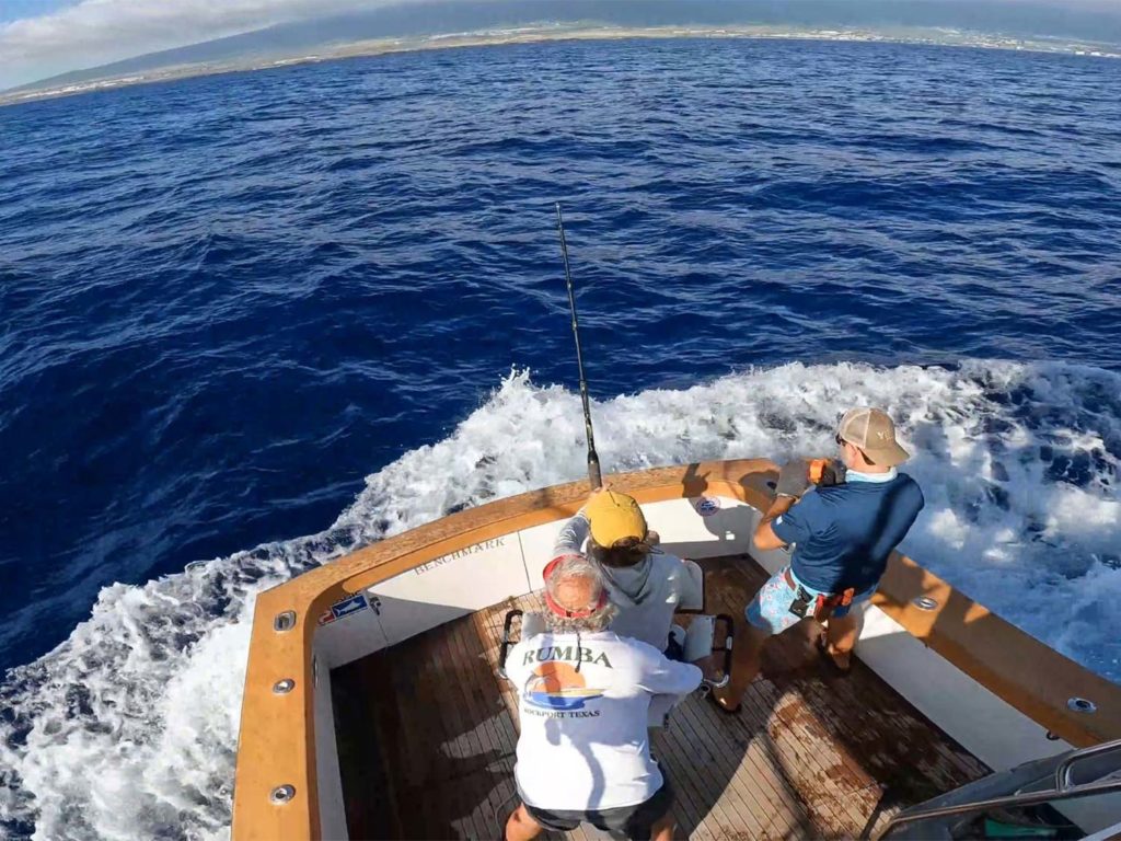 A sport-fishing angler and crew fishing in Kona, Hawaii.