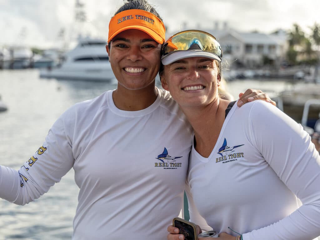 Two women standing on the docks of Bermuda.