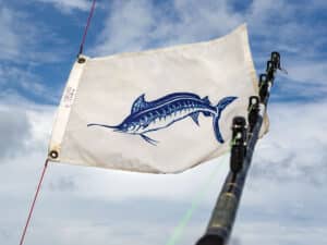 A white marlin release flag with the billfish colored in blue.