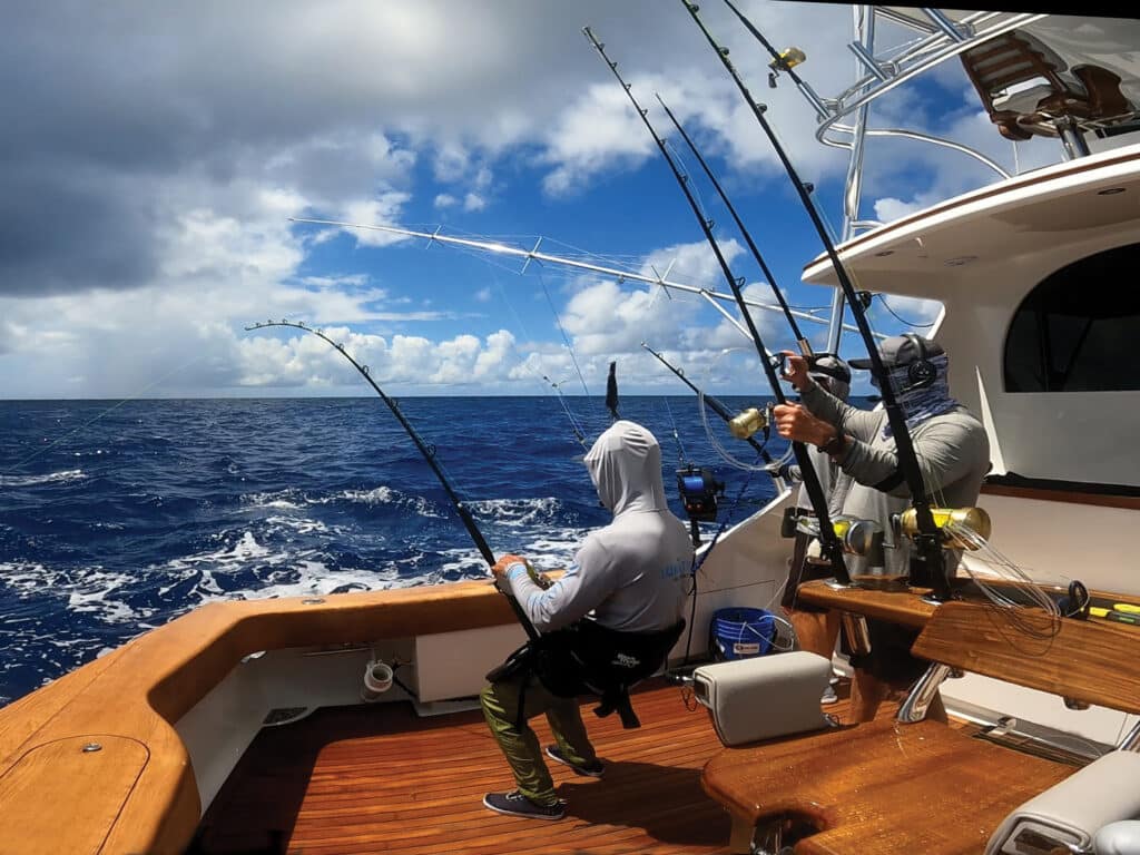 A sport-fishing angler fighting a blue marlin on the line.