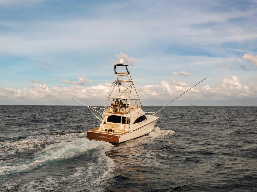 A sport-fishing boat cruises across the water.