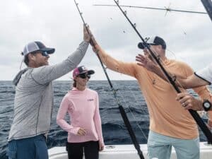A sport-fishing team celebrates after a marlin release.