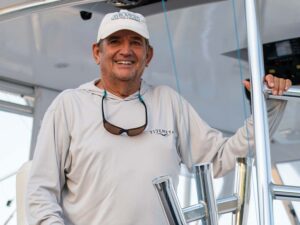 Capt. Bubba Carter stands in the tower of a sport-fishing boat to smile for the camera.