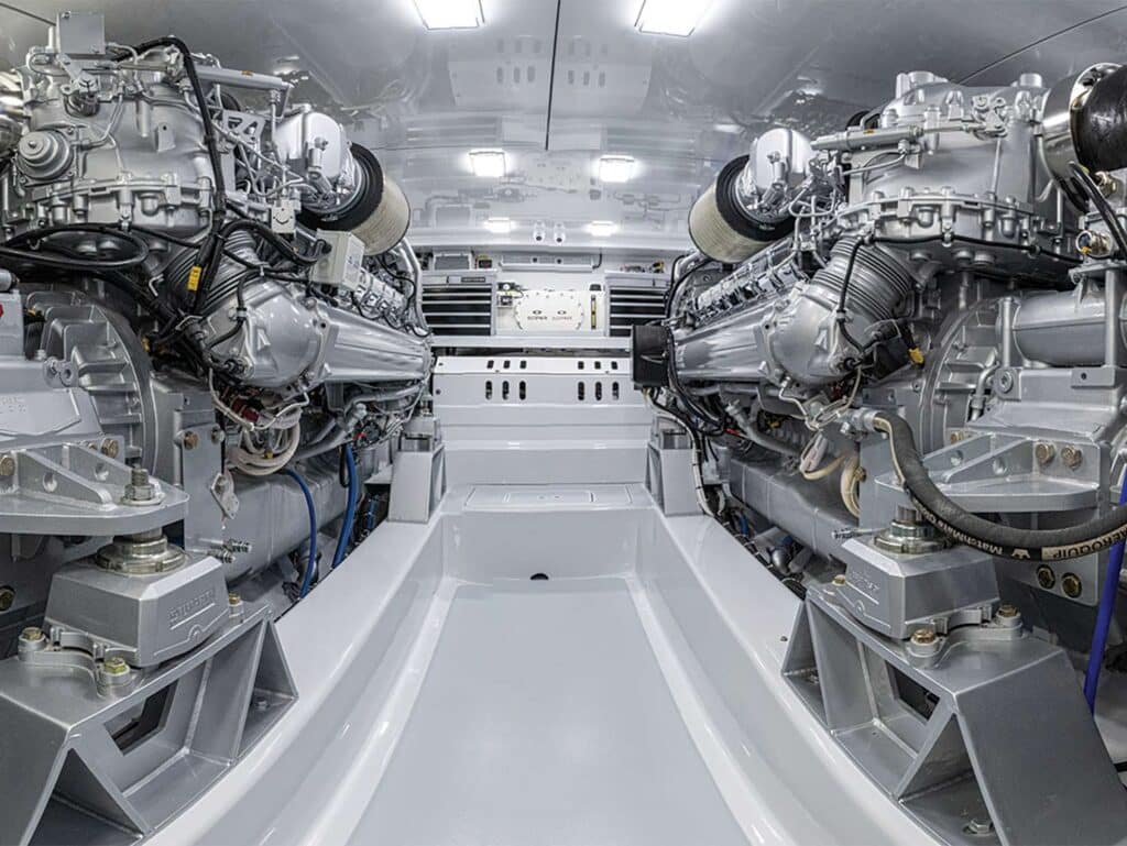 A clean and stark white engine room featuring two engines.