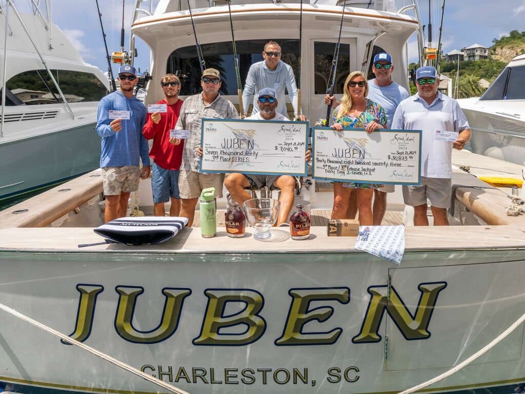 A sport-fishing team standing in the cockpit of a sport-fishing boat.