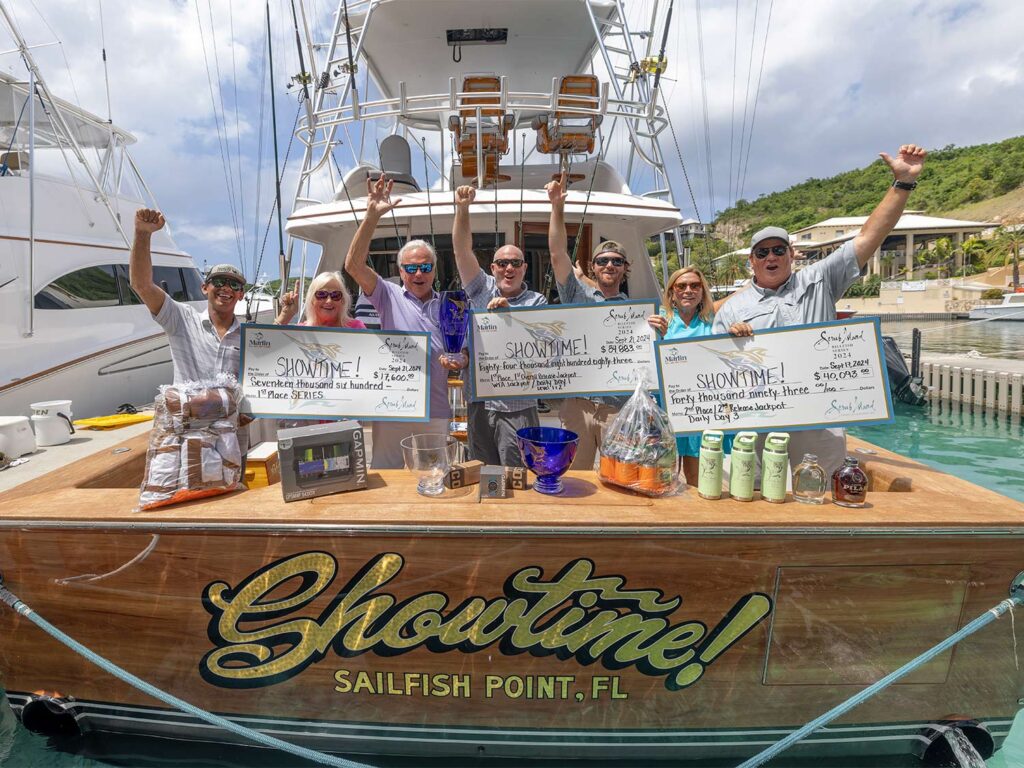 A sport-fishing team standing in the cockpit of a sport-fishing boat.