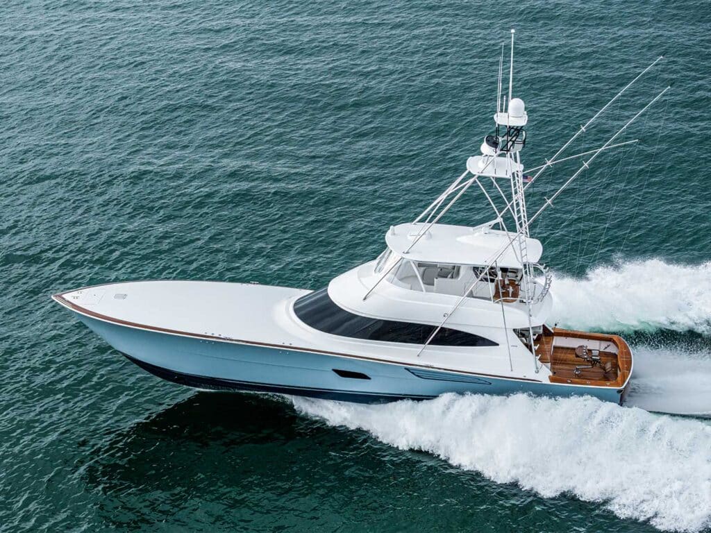 A Viking Yacht 82 sport-fishing boat cruising on the ocean leaving waves in its wake.