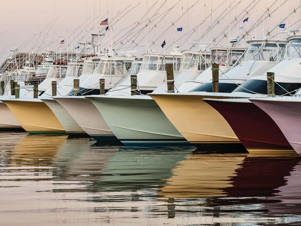 A line up of sport-fishing boats docked in a marina.