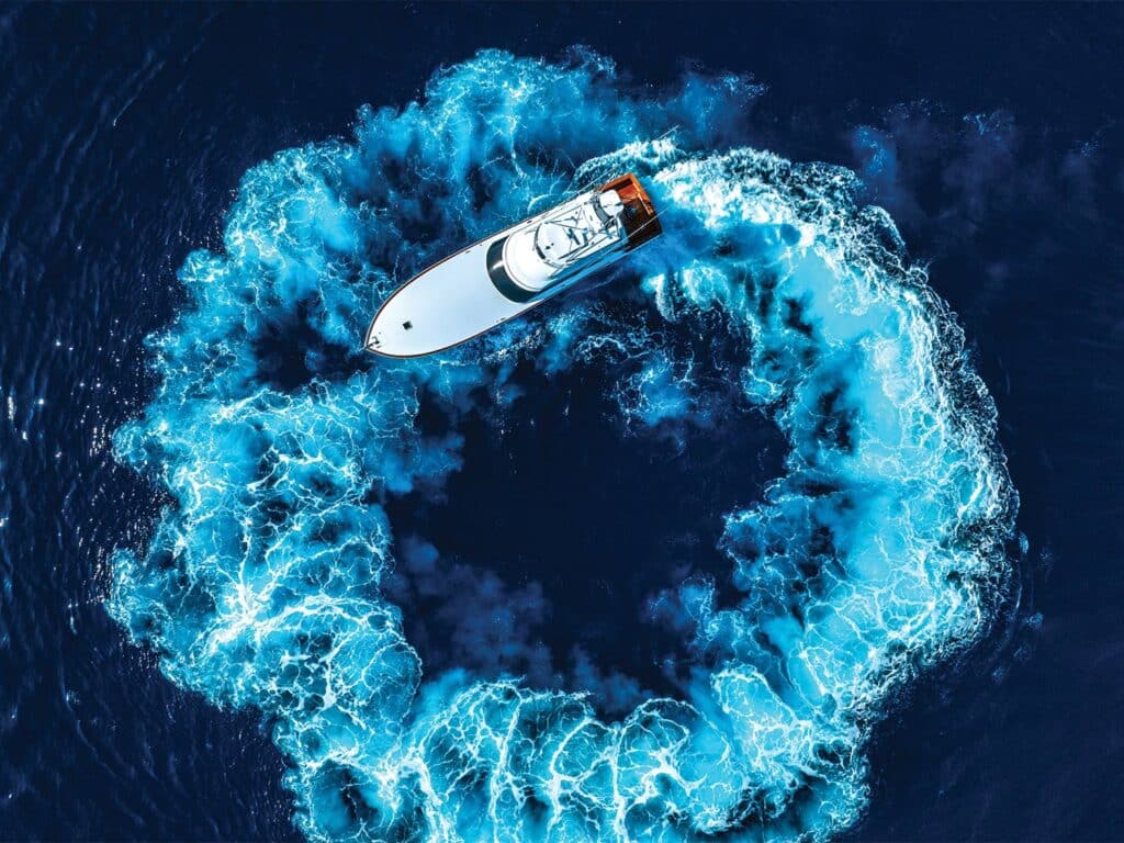 A sport-fishing boat turns in circles on the water.