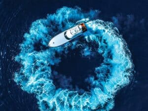 A sport-fishing boat turns in circles on the water.