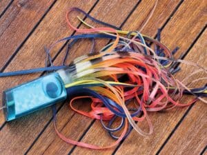 A sport-fishing lure on a wooden deck