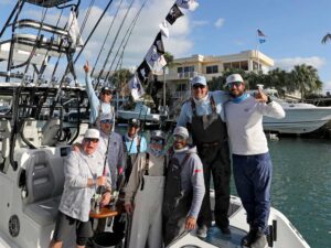 A sport-fishing team celebrating in the cockpit of their sport-fishing boat.