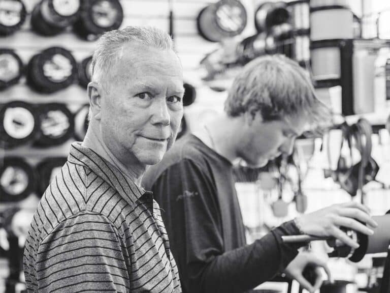 A black and white image of Bill Buckland in his shop.