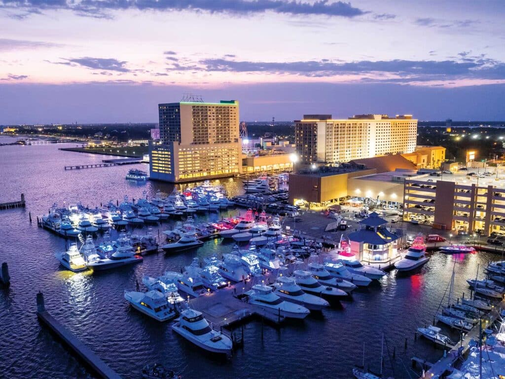 Aerial view of a sport-fishing marina lit up at night.